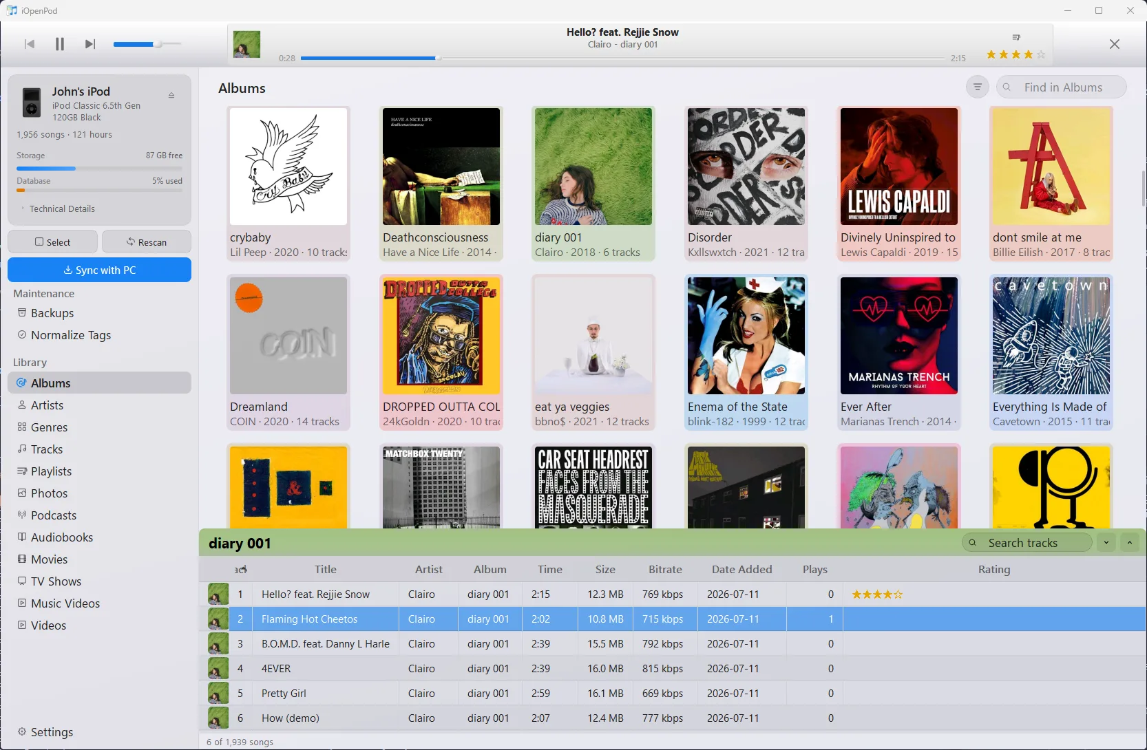 iOpenPod showing a connected iPod, album artwork browser, playback controls, and track details